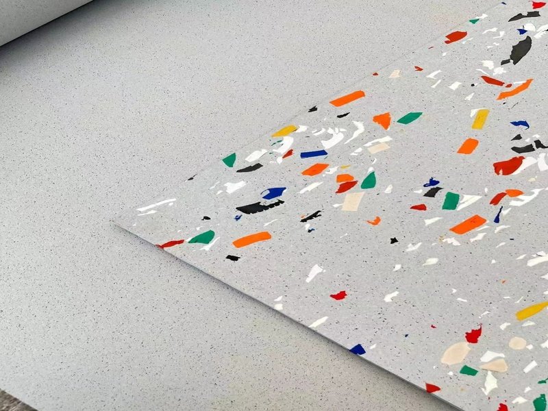 A close-up view of a heavy squat rack leg on a rubber floor, showing no signs of indentation